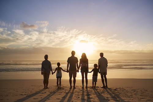 guests standing on the beach