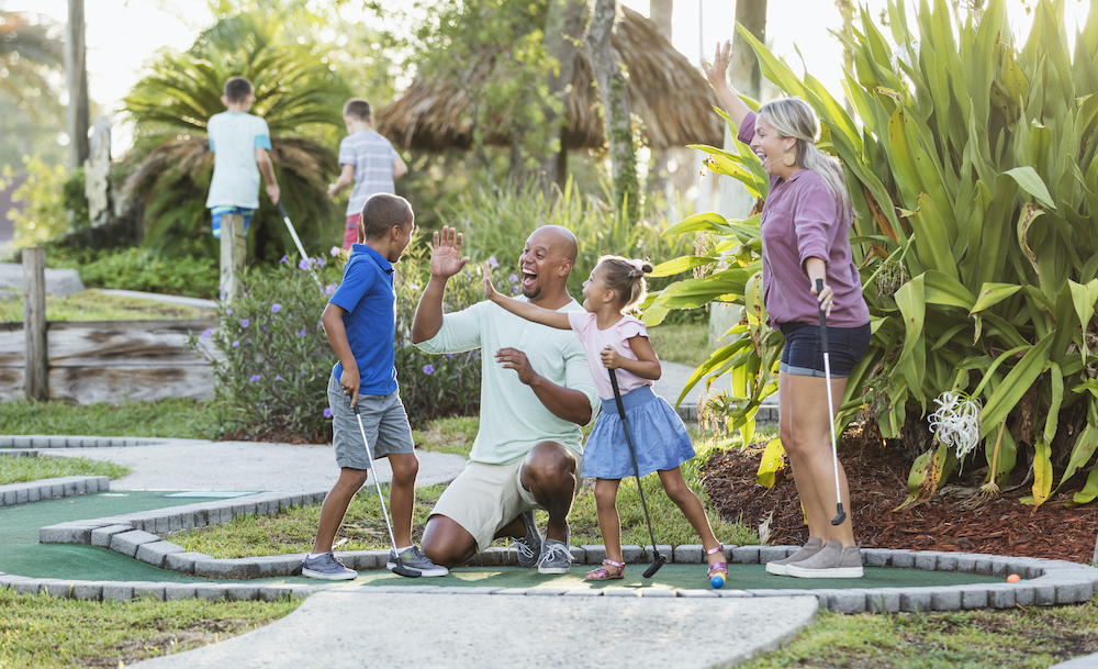 family playing mini golf